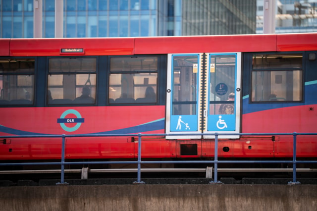 KeolisAmey Docklands Image - DLR train showing customers on the platform where to find the space for wheelchairs, buggies and other large items