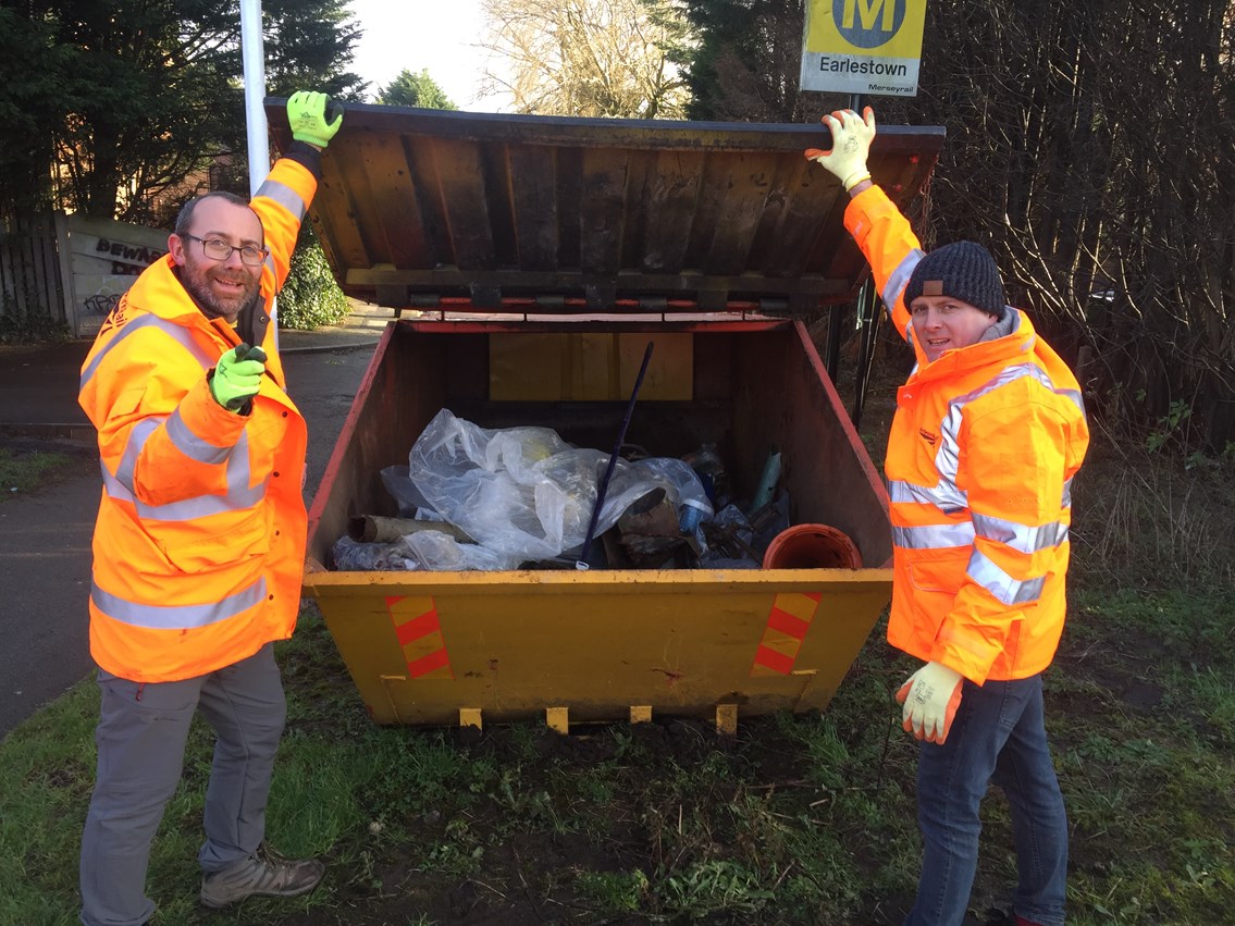 Mark Bellew and Wayne O'Reilly by a skip full of litter at Earlestown station