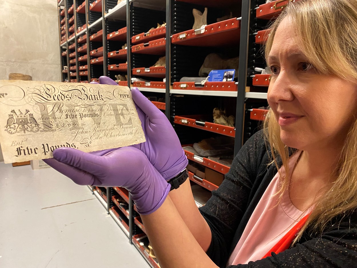 Money Talks: Kat Baxter, Leeds Museums and Galleries’ curator of archaeology and numismatics with one of the local bank notes carrying the branding of both the city itself and now defunct local banking institutions like The Leeds Bank, Leeds Union Bank and Leeds Commercial Bank.