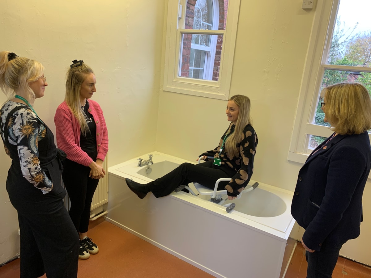 L-R: Third-year OT students Jessica Moore and Niamh Sweeney watching a bathroom demonstration led by Cumberland Council OT Sally Brown (seated) and Susie Wilson, (right) from University of Cumbria, at the university’s Fusehill Street on-campus clinical skills area