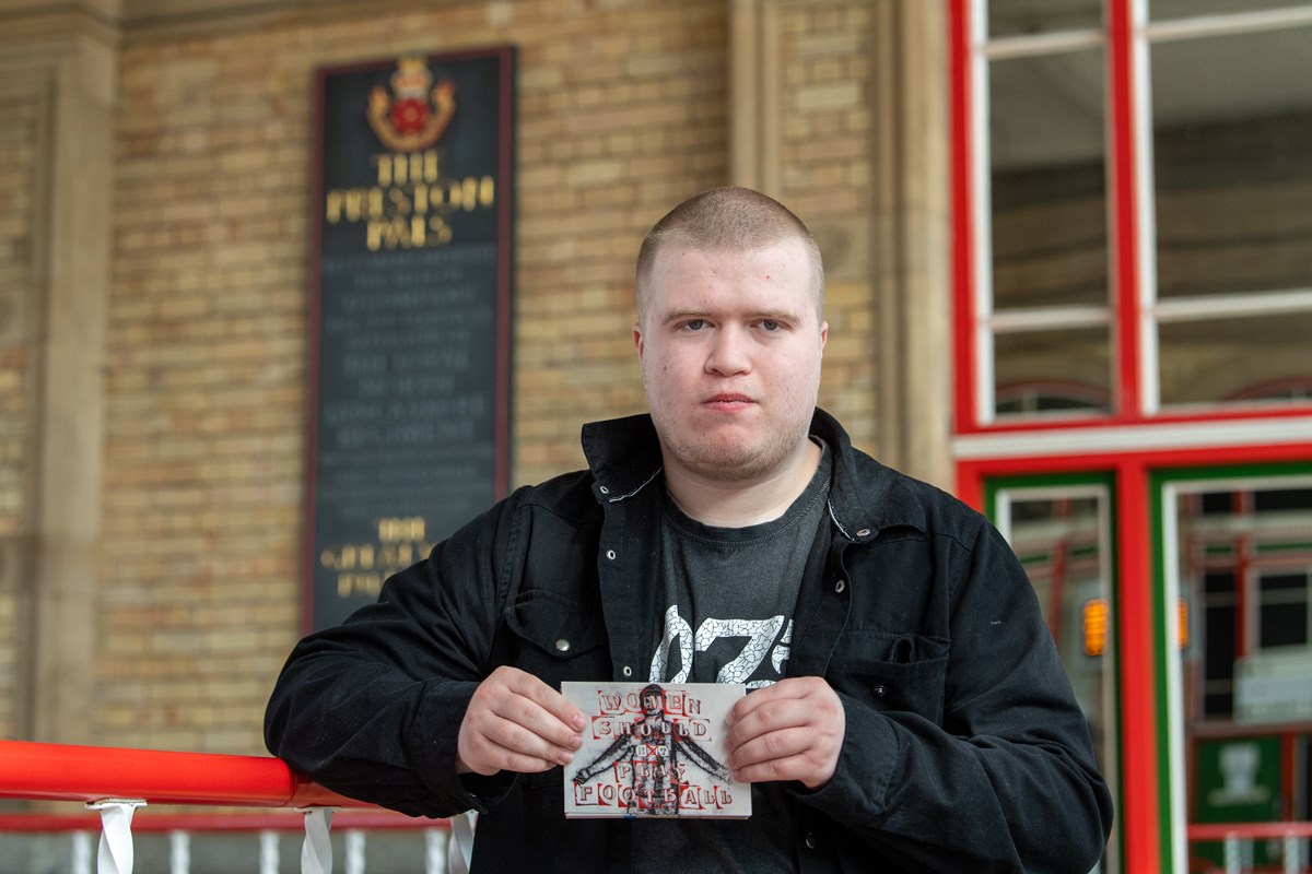 Matthew, intern from DFN Project SEARCH, holding a postcard he helped to design as part of the unique project to raise awareness of the Dick, Kerr Ladies football team