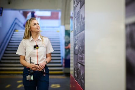 Abbie Wells, Avanti West Coast Welcome Host at Wigan North Western station, views a selection of photographs from the mural.