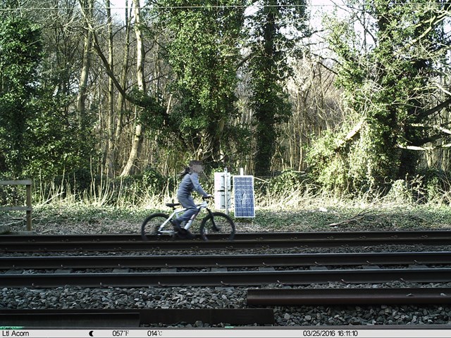 Child cycling on railway track