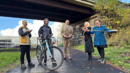 Cllr Warren Goldsworthy cuts the ribbon to officially open the new pathway with representatives from Preston City Council, Avanti, Network Rail and Community Rail Lancashire