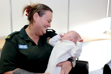 NEAS health advisor Toni Hackett with baby Sebastian, who she helped deliver