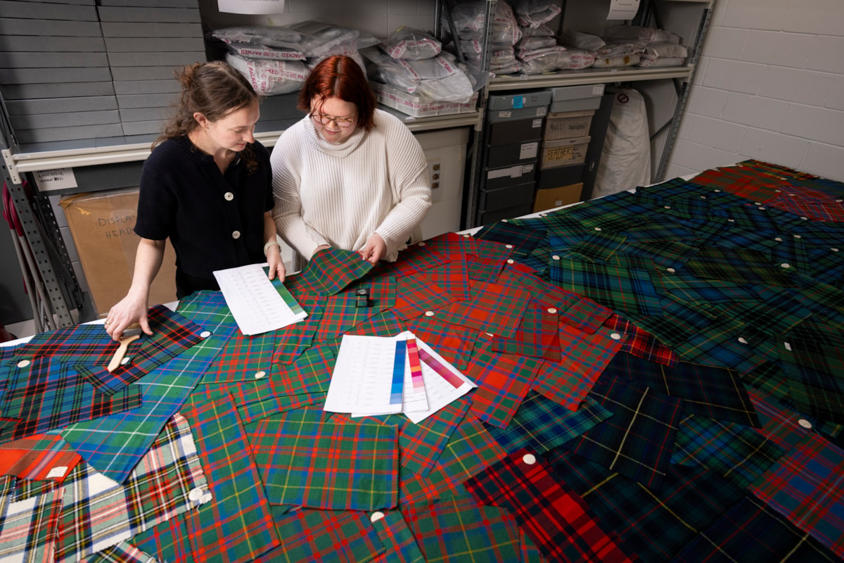 University of Glasgow students Lilly and Layla examine tartan samples. Photo © Duncan McGlynn (2)