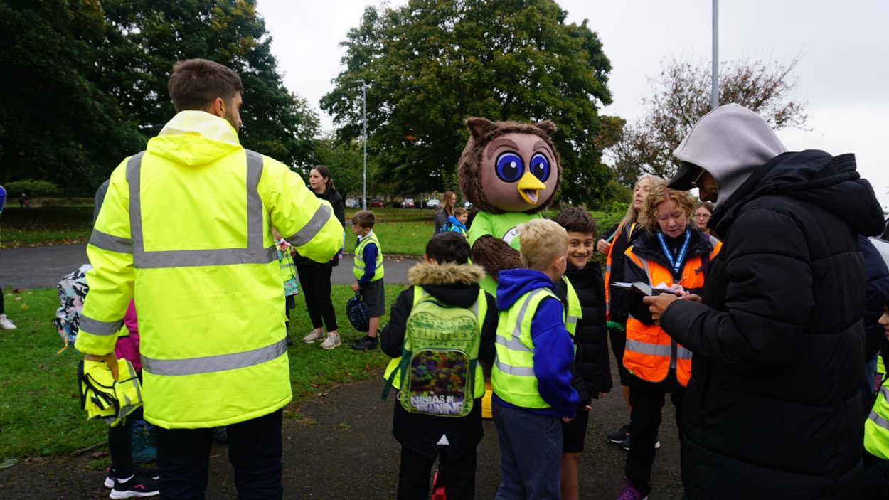 Arlo the Owl, the council's safe and sustainable travel mascot, meeting pupils from Ireland Wood Primary School before their walk to school: Arlo the Owl, the council's safe and sustainable travel mascot, meeting pupils from Ireland Wood Primary School before their walk to school