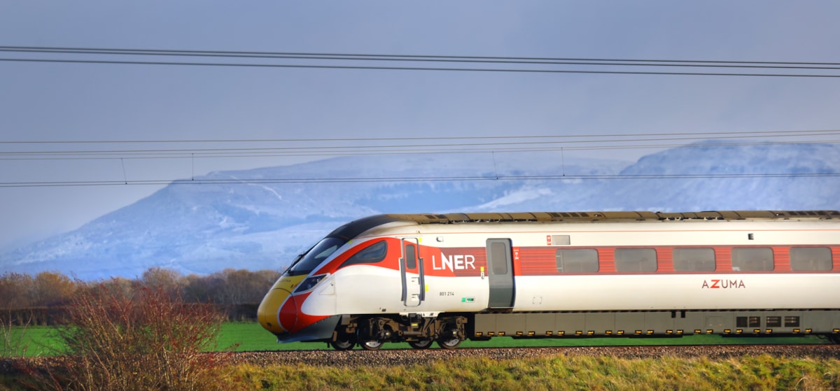 An LNER Azuma train passing through the countryside
