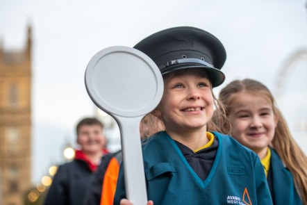 Pupils dress up in railway uniform at Avanti West Coast's celebration event in Parliament to mark the completion of its Feel Good Field Trips initiative.