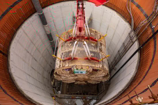 TBM Caroline lifted out of vent shaft at Green Park Way, Greenford - May 2025: HS2 lifts Tunnel Boring Machine (TBM) ‘Caroline’ from below ground at the Green Park Way site in Greenford, West London.

On Sunday 25th May, engineers working on the HS2 project lifted the TBM 9.48metre diameter cutterhead, front and middle shield, weighing 850 tonnes, using a large gantry crane. The tunnelling machine concluded its 5mile journey from West Ruislip in April, arriving in an underground reception chamber. TBM Caroline excavated over 1.2 million tonnes of earth and installed 4,217 tunnel rings.