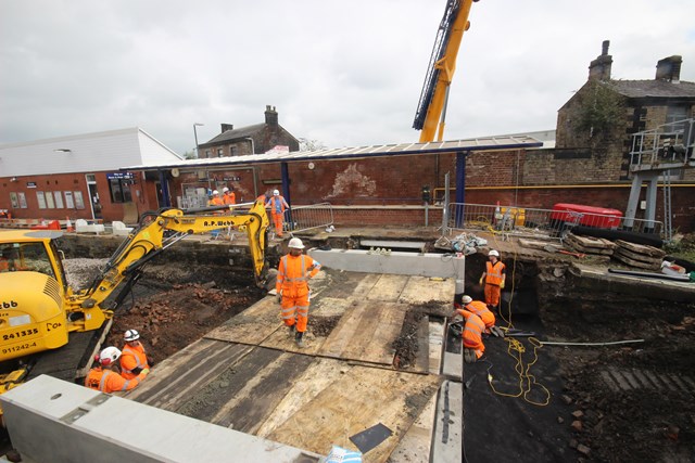 Orange army working on the new subway at Chorley station