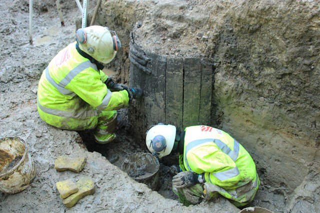 Archaeologists excavate one of the medieval timber wells ©MOLA