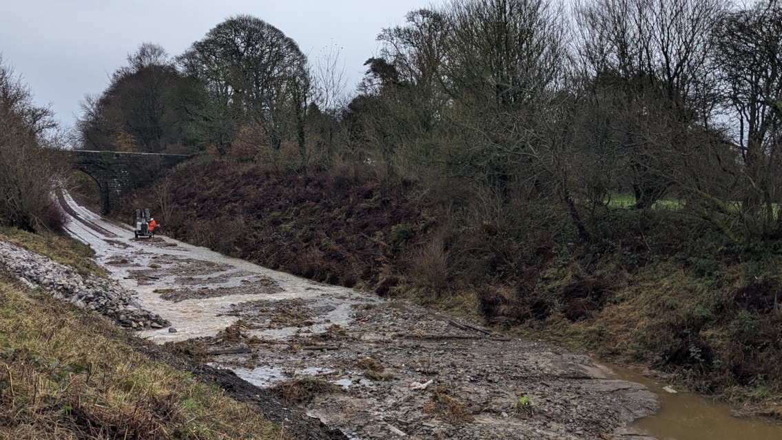 Network Rail is working to resolve the flooding and collapsed cutting in Ulverston