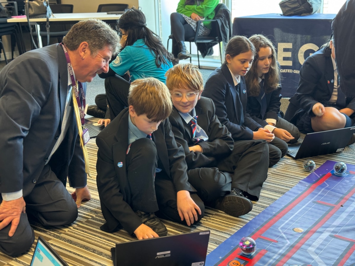 Lancashire County Cllr Brian Moore, cabinet member for .Economic Development and Growth discusses the tasks in hand with pupils at the Lancaster and Morecambe MEGA Hub.JPG