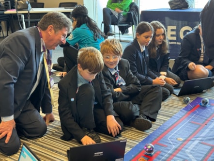 Lancashire County Cllr Brian Moore, cabinet member for .Economic Development and Growth discusses the tasks in hand with pupils at the Lancaster and Morecambe MEGA Hub.JPG