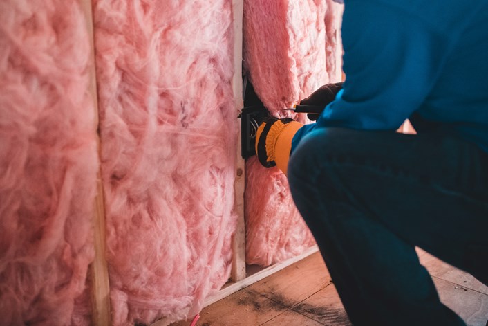 Photo by Erik Mclean on Unsplash: Insulation being installed