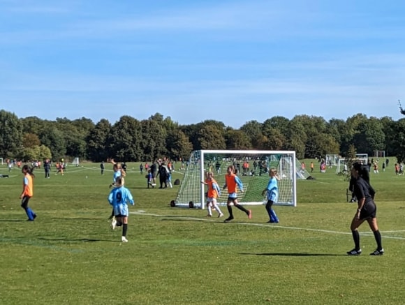 Surekha Griffiths, FA Grassroots Official of the Year 2023, referees Brent Cross under 11s girls' team to mark the London Overground Lioness line at Regent's Park