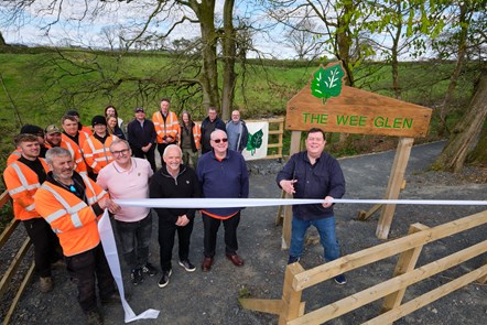 Councillor  Douglas Reid cuts the ribbon to open The Wee Glen with Cllrs McMahon, Canning and McGhee with the team from EA Woodlands