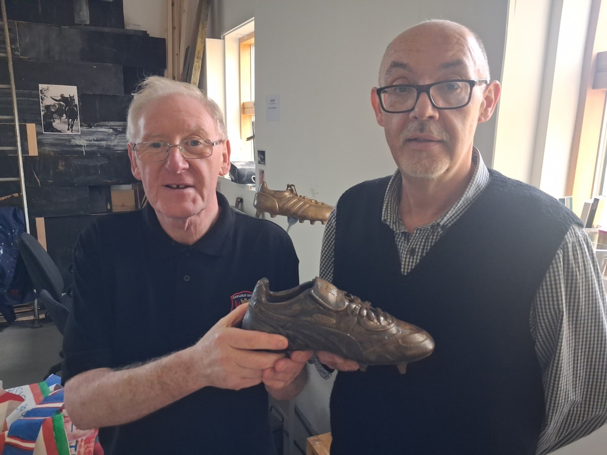 L-r: John Notman from the Carlisle United Heritage Group with Paul Forsyth, one of the two University of Cumbria graduate artists in residence who have created a new centrepiece for the club's Memory Garden based on boots relevant to periods of the club's history