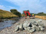 Boulders stacked and ready to be placed in the channel: Boulders stacked and ready to be placed in the channel