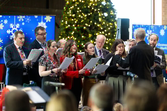 Colleagues from across the rail industry singing together in a choir, LNER
