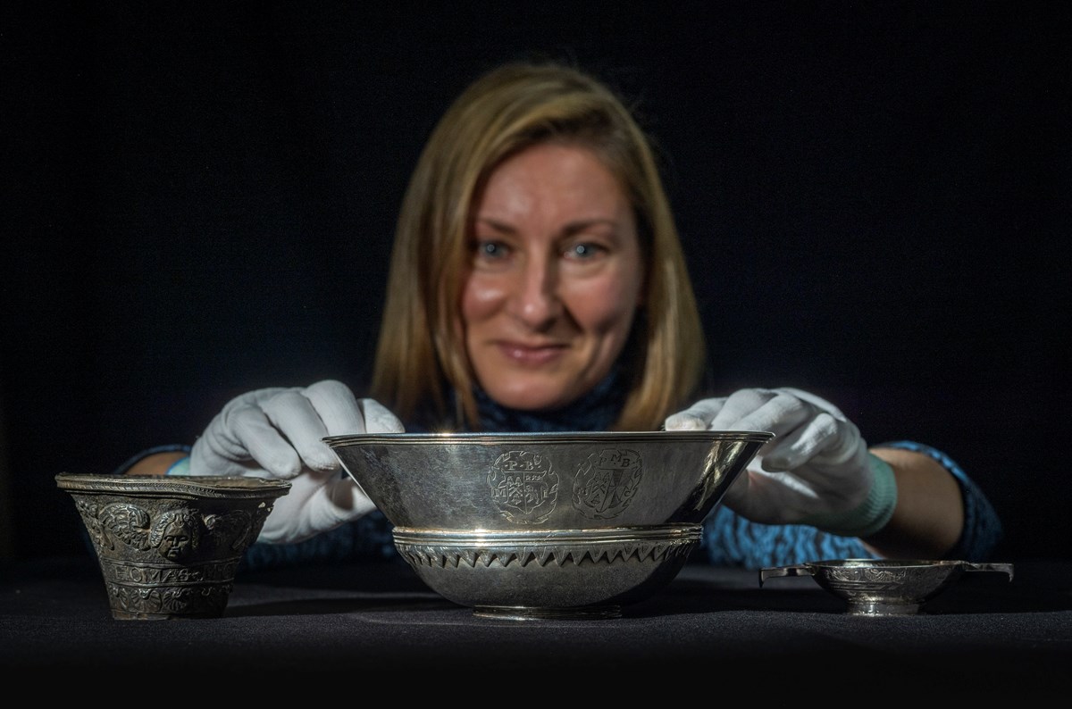 Lyndsay McGill, Curator of Renaissance and Early Modern History at National Museums Scotland with the 17th century silver trumpet bell, mazer and quaich. Photo © Phil Wilkinson