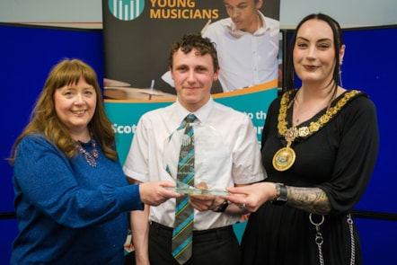 Provost Leitch and Councillor Cowan present Gregor with this award