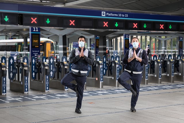 Rail Wellbeing Live Attracts 13,000 from Across Rail Industry: Station Staff at Barrier in Tree Pose with masks