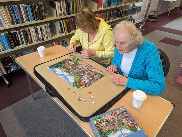 Library guests enjoying a jigsaw