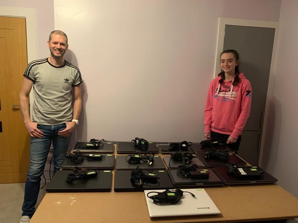 Steven Dunbar and daughter, Katie, with laptops set out on table