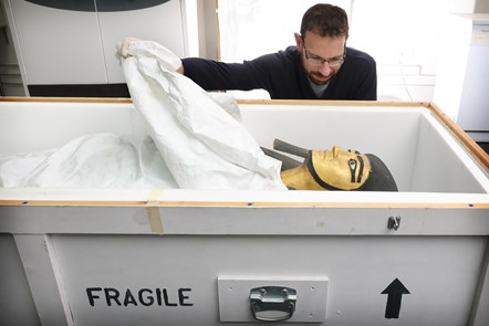 Conservator Charles Stable unpacks the anthropoid coffin of the estate overseer Khnumhotep. Photo © Stewart Attwood