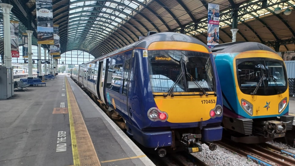 Image shows a Northern train and TransPennine Express train at Hull station