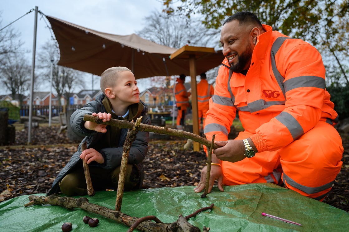 A pupil and SIG volunteer in the new Forest School at Paget Primary School