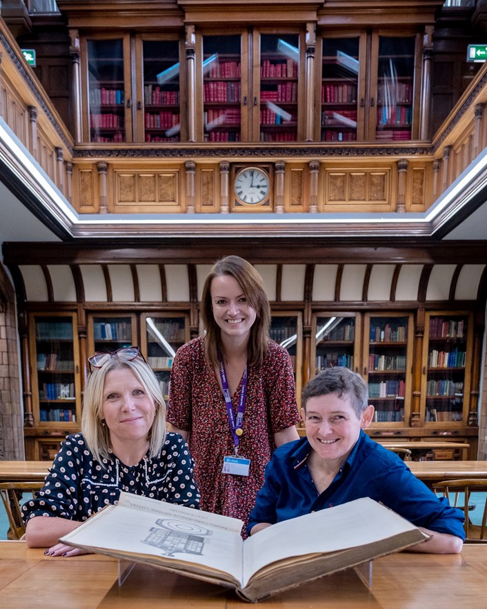 Engineery: Rhian Isaac, Leeds Central Library's special collections librarian, with  Abby Dix-Mason and Jane Earnshaw of the Smeaton300 project (seated) and the book containing original plans for John Smeaton's famous Eddystone Lighthouse. The beautiful first edition, penned by Smeaton himself, is on loan from Leeds Central Library, and is among the fascinating objects featured in Engineery, a new exhibition which has opened at Leeds Industrial Museum. Image credit: Anthony Robling.