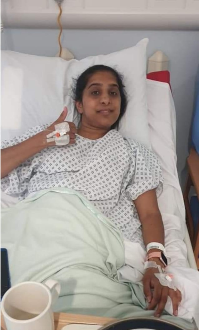 Kidney donor appeal 4: Image shows Surinder in a hospital bed, with thumbs up and smiling.