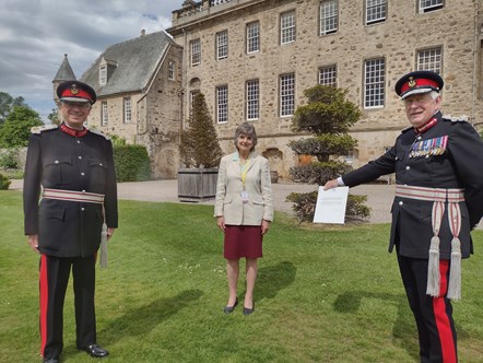 L-R: Lord-Lieutenant of Banffshire, Andrew Simpson; Deputy Lieutenant Joanna Grant Peterkin; Lord-Lieutenant of Moray, Major General Seymour Monro with the letter from Buckingham Palace