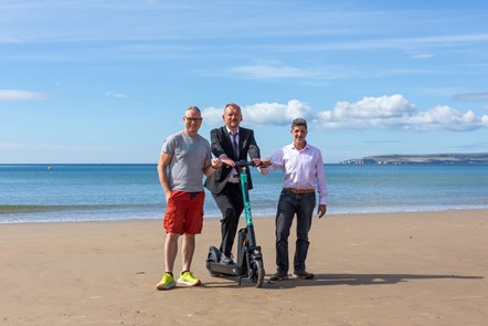 From left to right - Beryl BCP scheme Leader, Martin Jolly, BCP Council Portfolio Holder for Transport and Sustainability, Councillor Mike Greene and BCP Council Accessibility Team Leader, Nick Philip celebrate the landmark of one million journeys achieved in the Bournemouth Christchurch and Poole b