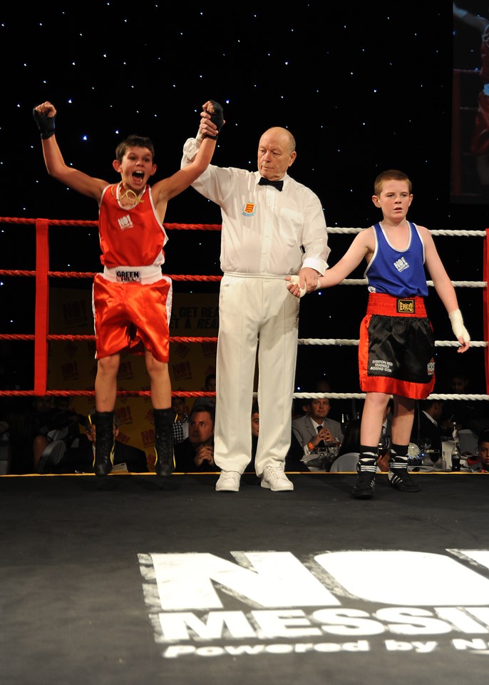 Jerry Connors (in red) from St Joseph's community club in Newport is delighted at his win over Everton boxer Lewis Gorman (in blue) at the No Messin' Tri-nation boxing competition: Jerry Connors (in red) from St Joseph's community club in Newport is delighted at his win over Everton boxer Lewis Gorman (in blue) at the No Messin' Tri-nation boxing competition