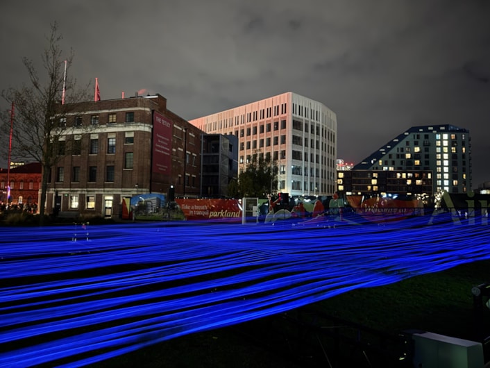 Aftereal - Yasuhiro Chida: For Aftereal at Aire Park, visitors can watch a luminous landscape ripple before their eyes as hundreds of fluorescent threads rise, fall and shimmer in ultraviolet light.