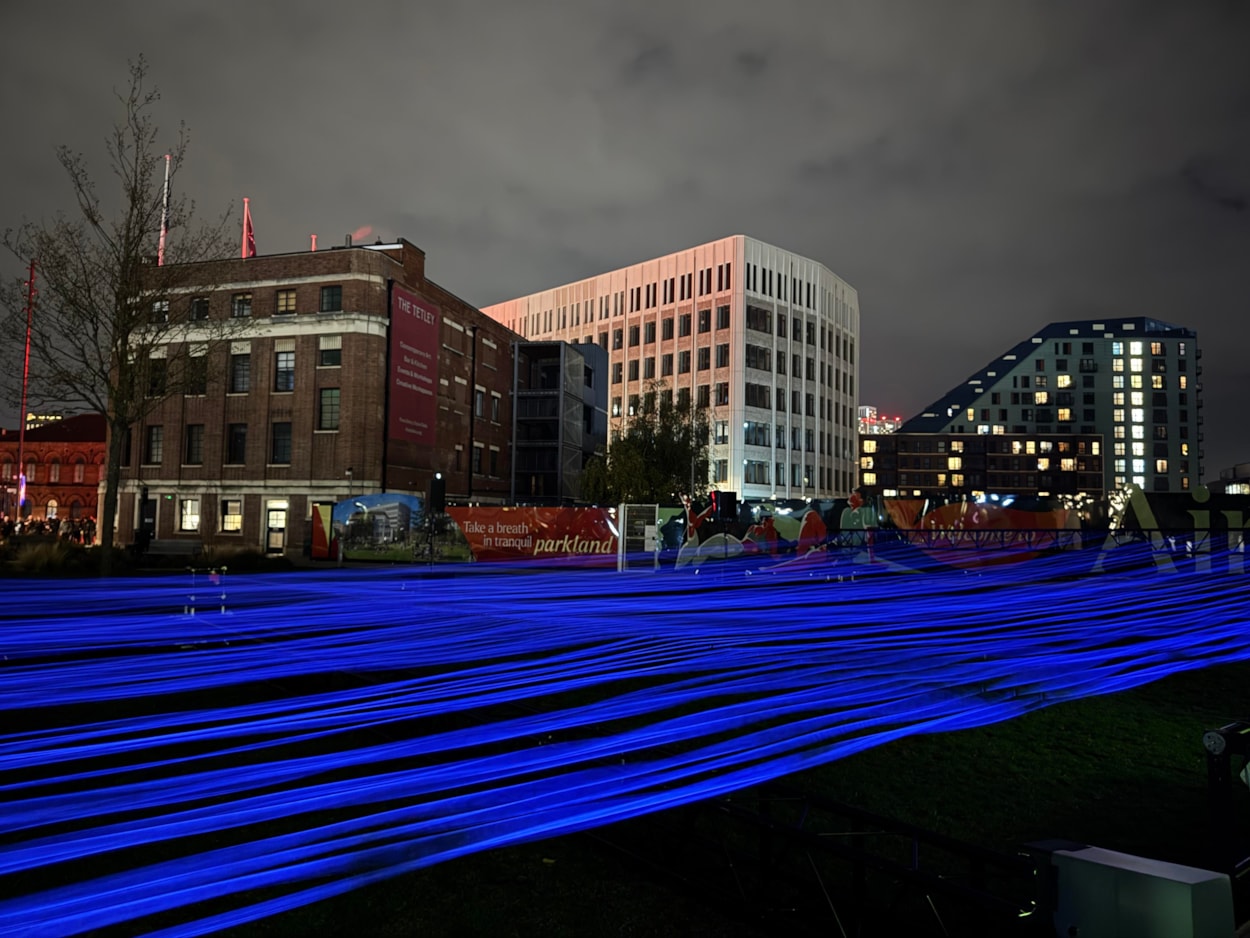 Aftereal - Yasuhiro Chida: For Aftereal at Aire Park, visitors can watch a luminous landscape ripple before their eyes as hundreds of fluorescent threads rise, fall and shimmer in ultraviolet light.