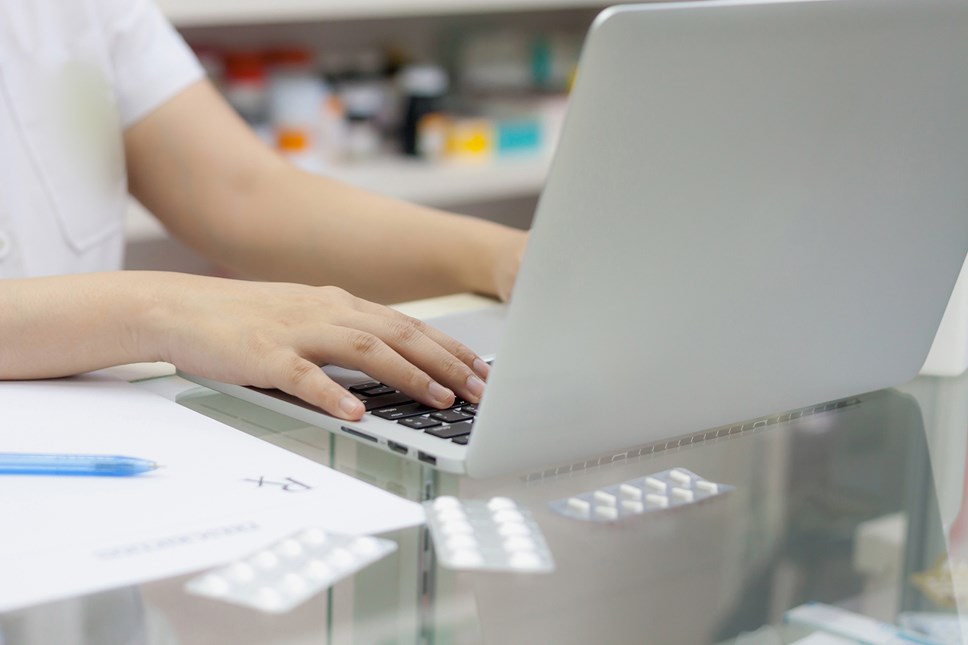 A pharmacist using a laptop