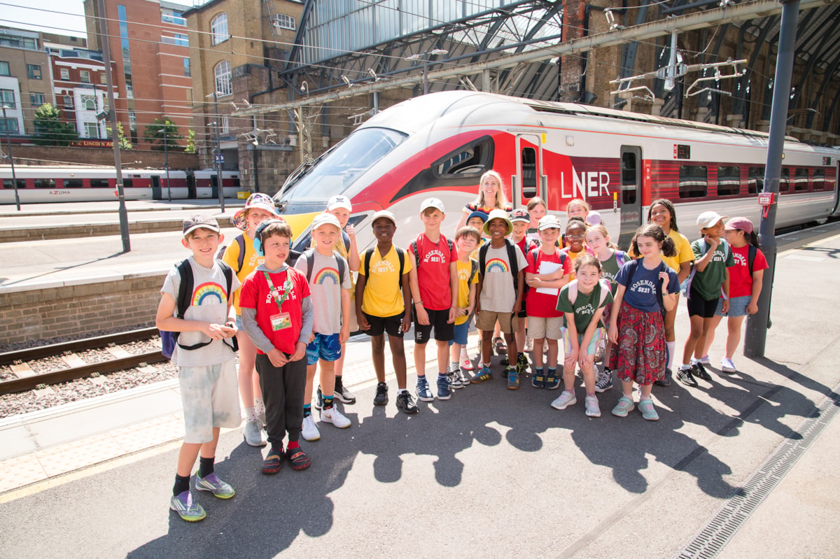 Sara Pascoe with children at King's Cross Station in front of LNER Azuma Train