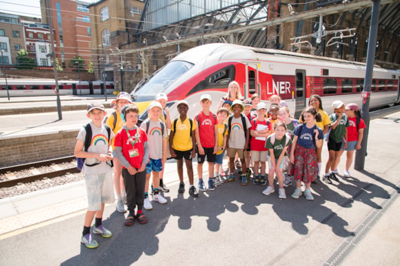 Sara Pascoe with children at King's Cross Station in front of LNER Azuma Train