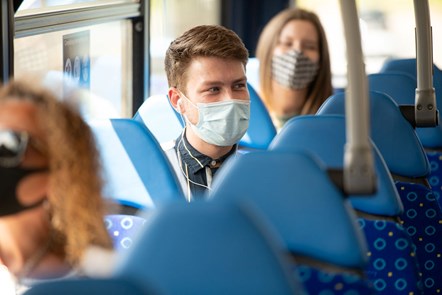 Male passenger on Metrobus wearing face covering