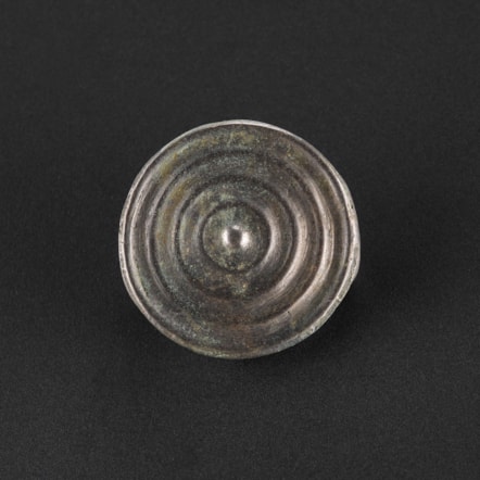 Decorated bronze button from the Peebles Hoard. Photo © National Museums Scotland