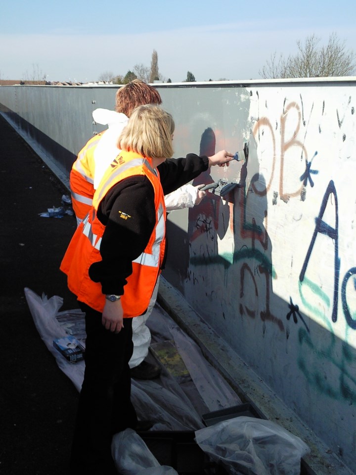 Young offender working with Network Rail staff: Painting bridge at Turner's footbridge