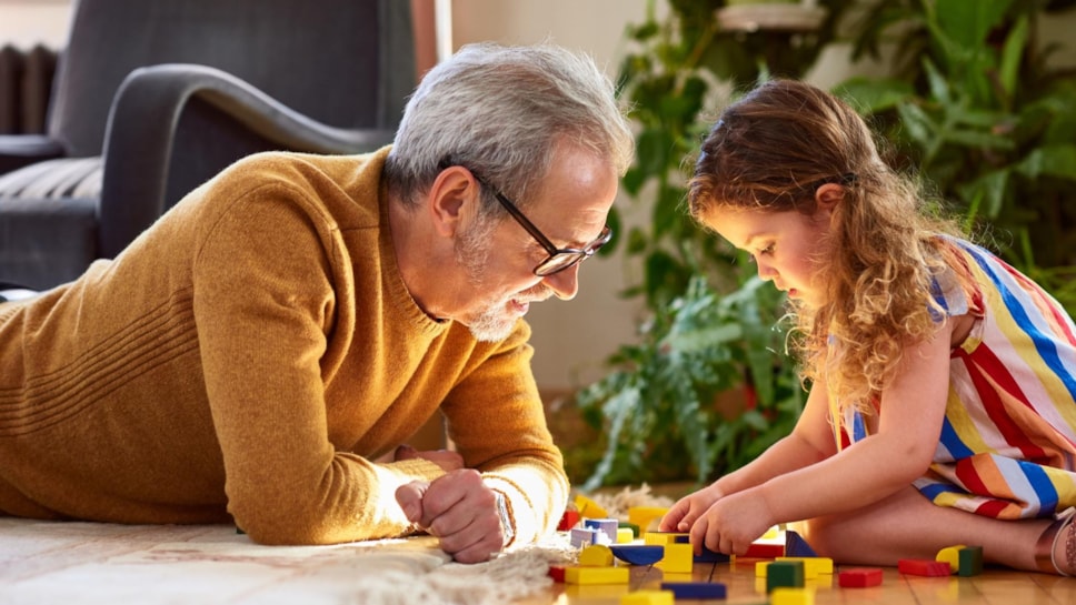 Grandfather and granddaughter playing