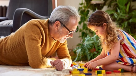 Grandfather and granddaughter playing