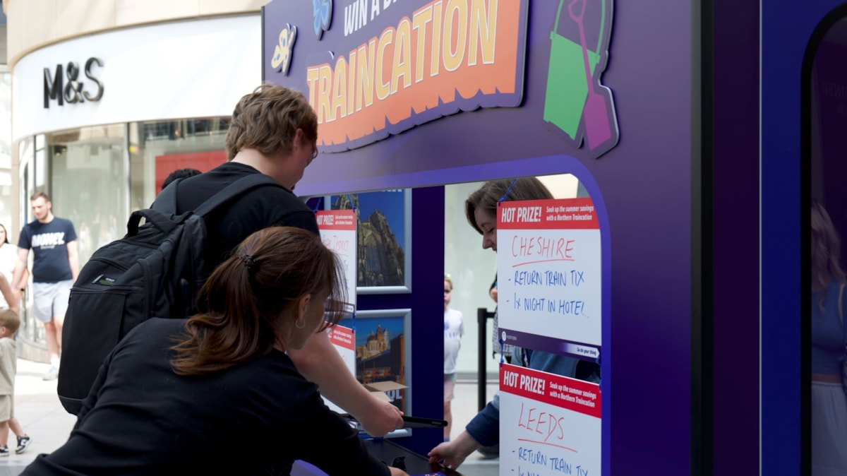 Image shows pop-up travel agency at Trinity Leeds promoting Traincations - close-up