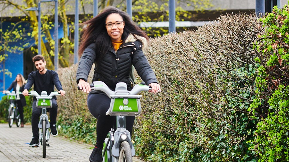 Young woman riding a bike for hire